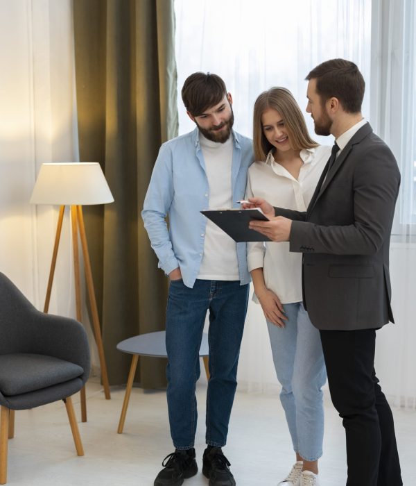 male-real-estate-agent-doing-business-showing-house-potential-buying-couple (1)